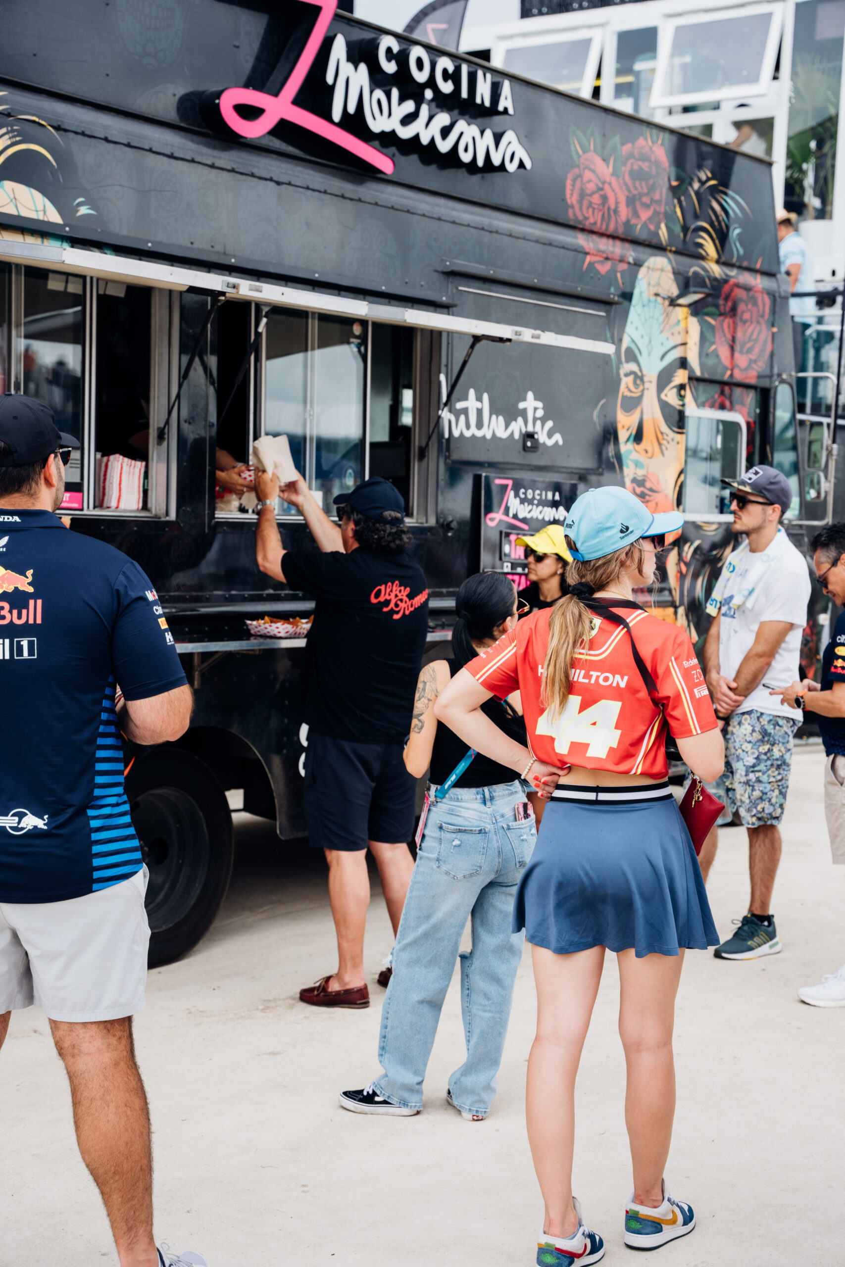 photo of people lining up in front of a food truck