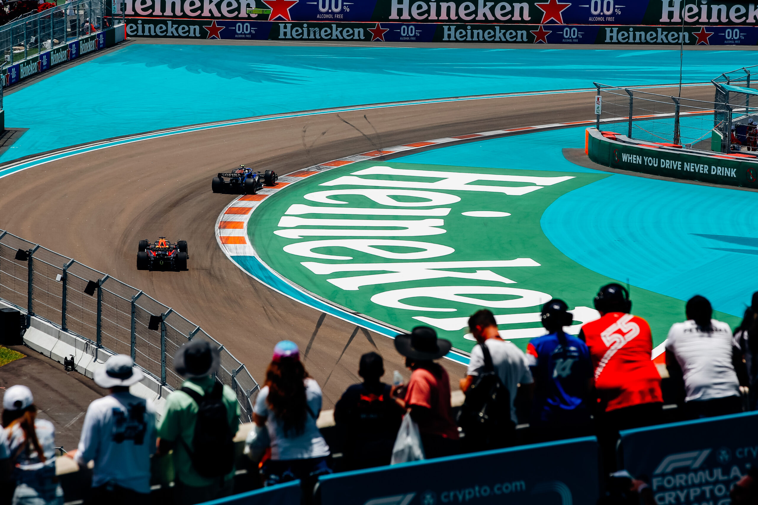 Photo of fans watching the race cars pass by from a viewing deck