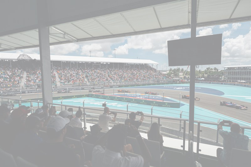 240504-MiamiGP-PM104 copy People watching the race with privileged view of the first turn while cars zoom by