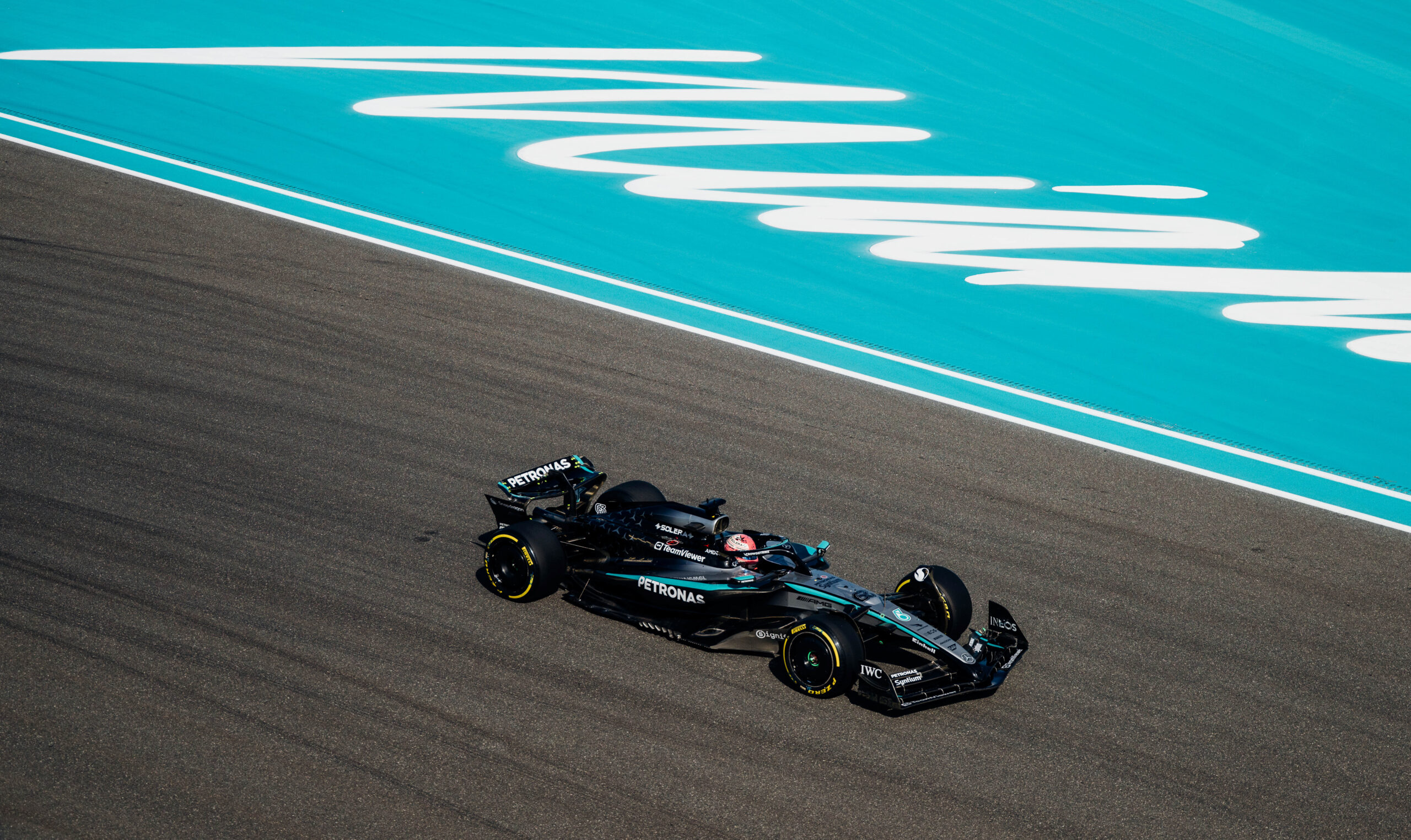 A lone car races past the Miami logo on the F1 track.