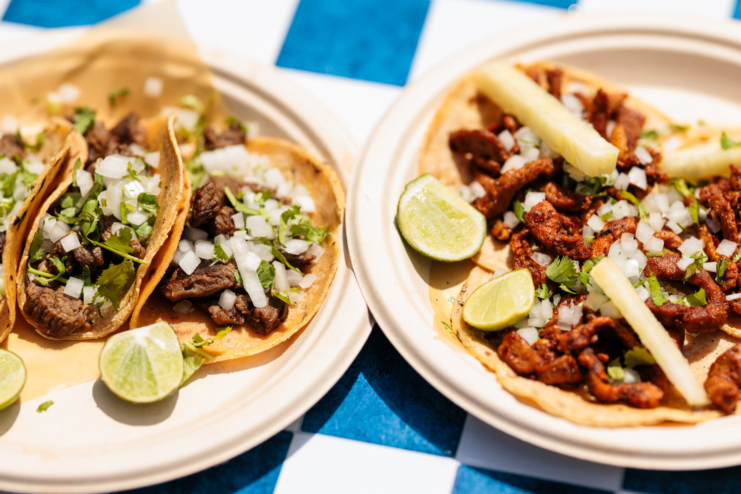 Tacos served on a blue checkered tablecloth