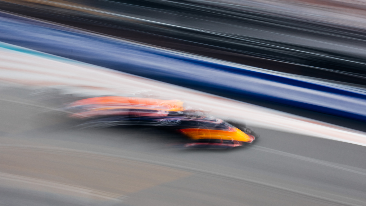 Oracle Red Bull car races down Miami F1 track with blurred background.