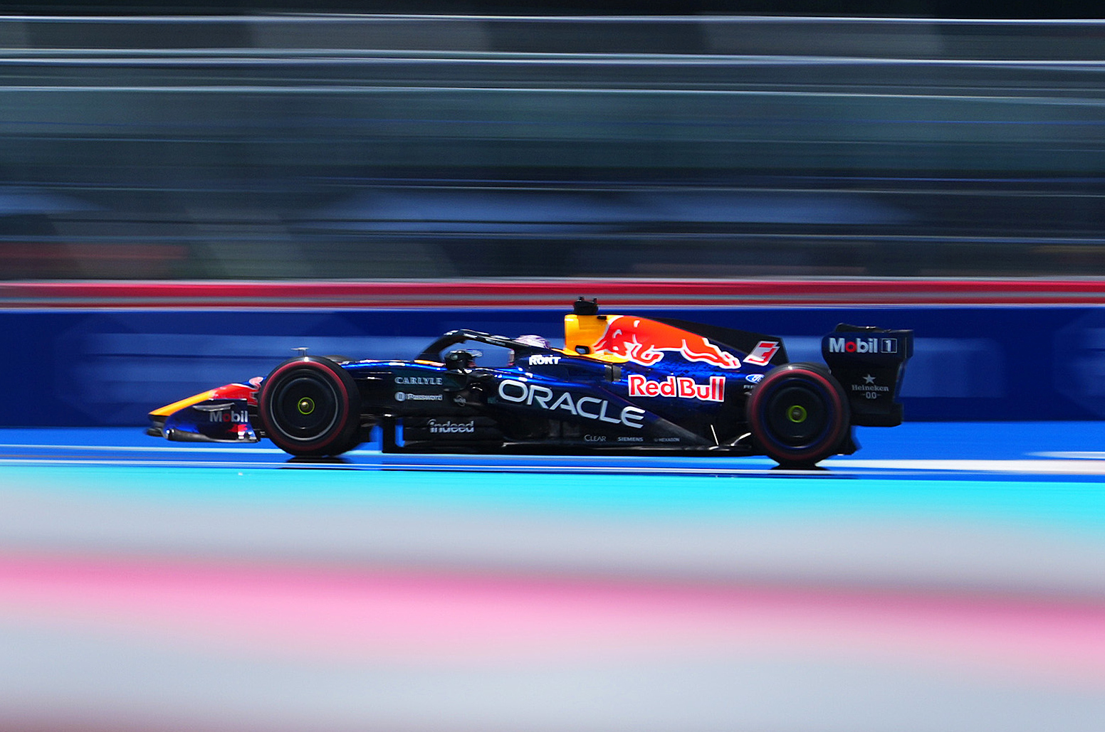 F1 Grand Prix of Miami – Practice & Sprint Qualifying ide-profile panning shot of a Red Bull Formula 1 car racing through the Miami Grand Prix circuit, with the background blurred to emphasize speed and motion